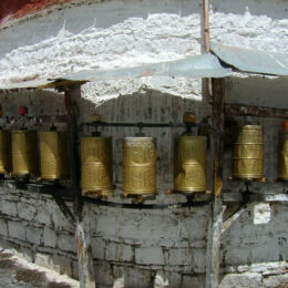 Prayer wheels contain old scriptures. When one passes by and spins the wheel, this action is equivalent to reciting the mantra.